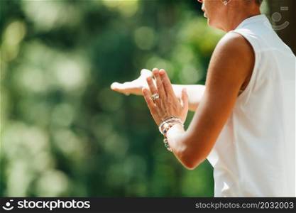 Woman Practicing Tai Chi Chuan Outdoors. Close Up On Hand Position. Woman Practicing Tai Chi Chuan Outdoors