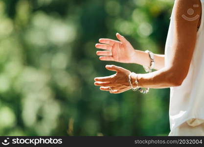 Woman Practicing Tai Chi Chuan Outdoors. Close Up On Hand Position. Woman Practicing Tai Chi Chuan Outdoors