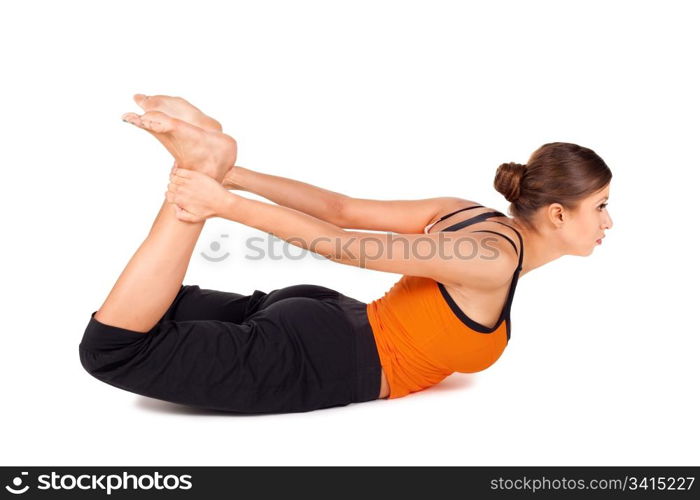 Woman practicing yoga exercise called Bow Pose sanskrit name: Dhanurasana, this pose improves posture, rejuvenates the spine, enhancing blood circulation, stretches ankles, thighs and groins, abdomen, chest, throat, and deep hip flexors, strengthens back muscles