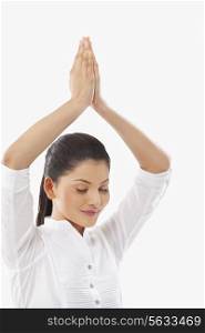 Woman practicing yoga with arms raised