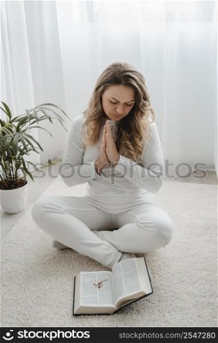 woman praying home floor