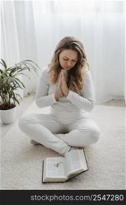 woman praying home floor