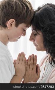 woman praying with her boy