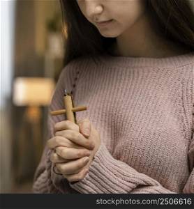 woman praying with wooden cross 2