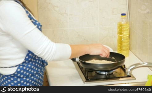 Woman preparing chebureki (popular meal of Tatar and Caucasian cuisine) at home