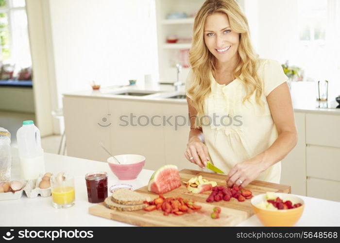 Woman Preparing Healthy Breakfast In Kitchen