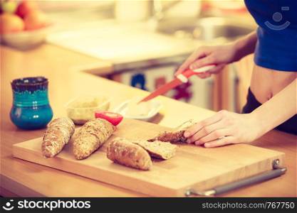 Woman preparing healthy breakfast making delicious sandwich in kitchen. Good dieting concept.. Woman preparing healthy breakfast making sandwich