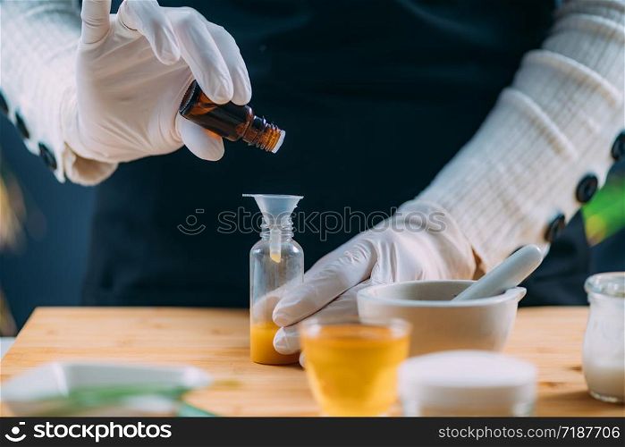 Woman Preparing Homemade Cream with Essential Oil Extracts