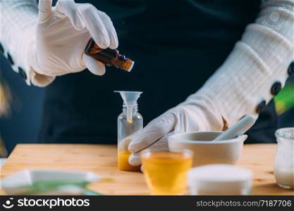 Woman Preparing Homemade Cream with Essential Oil Extracts