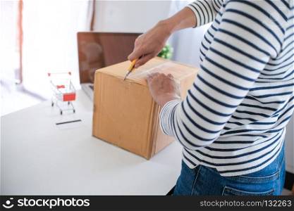 woman preparing package delivery box at home online order shopping
