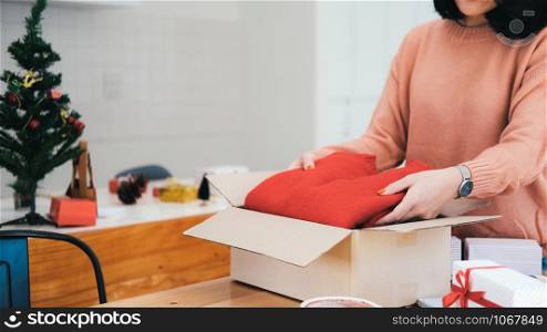 Woman preparing presents for Christmas and New Year. Holiday concept.