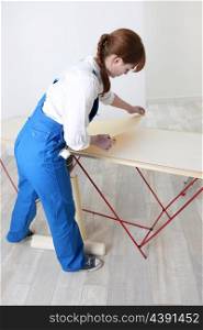 Woman preparing to wallpaper