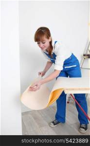 Woman preparing wallpaper