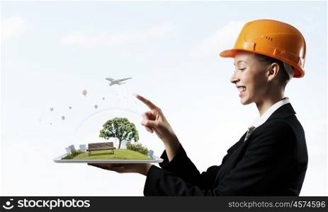 Woman presenting construction model. Woman engineer in hard hat showing construction project