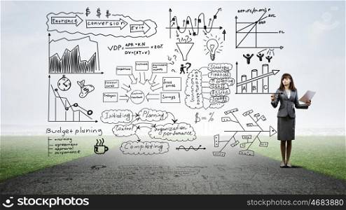 Woman presenting her business ideas. Young businesswoman on road drawing strategy plan on screen