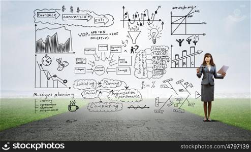 Woman presenting her business ideas. Young businesswoman on road drawing strategy plan on screen