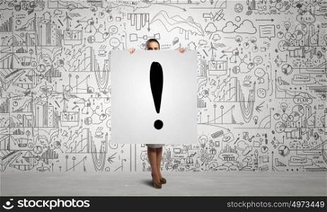 Woman presenting her idea. Young businesswoman showing banner with exclamation mark and strategy sketch at background