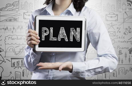 Woman presenting her plan. Young attractive woman showing financial plan on tablet computer