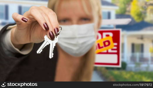 Woman Presenting House Keys Wearing Medical Face Mask.