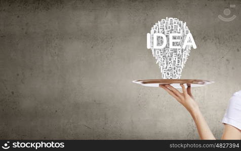 Woman presenting idea. Hand of woman holding tray with successful idea concept