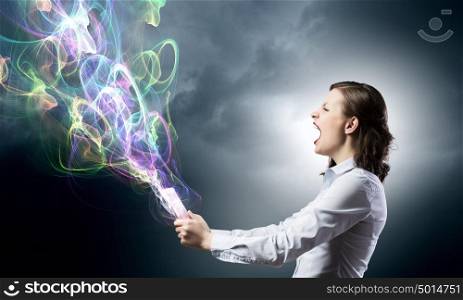 Woman presenting tablet pc. Attractive young woman using tablet and colorful lights out from device