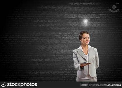 Woman presenting tablet pc. Young attractive businesswoman with tablet pc against digital background
