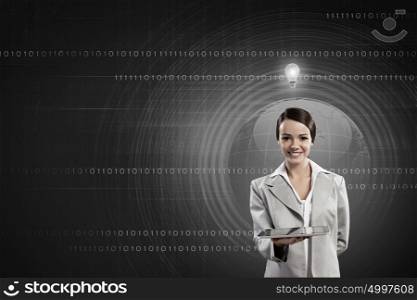 Woman presenting tablet pc. Young attractive businesswoman with tablet pc against digital background