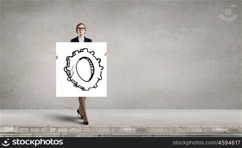 Woman presenting teamwork concept. Businesswoman holding placard with cogwheel as teamwork symbol