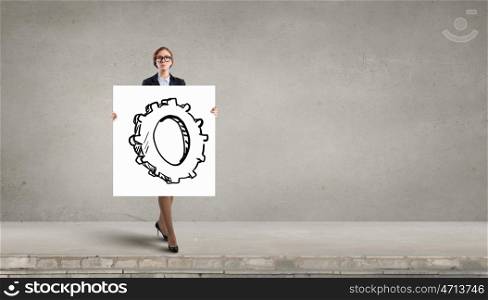 Woman presenting teamwork concept. Businesswoman holding placard with cogwheel as teamwork symbol
