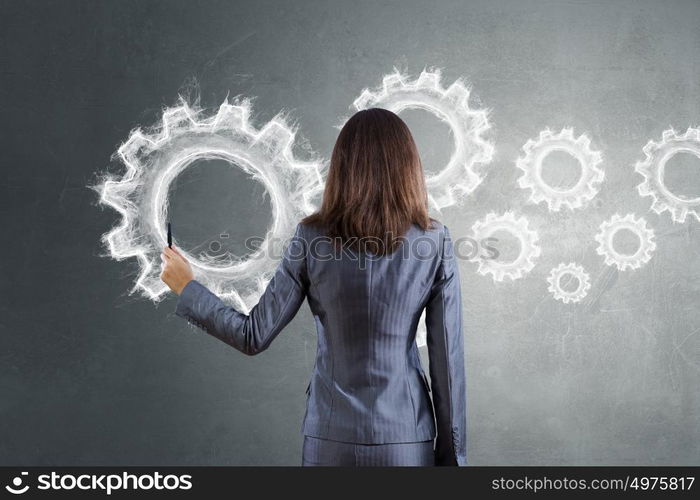 Woman presenting teamwork concept. Businesswoman standing with back and drawing teamwork concept