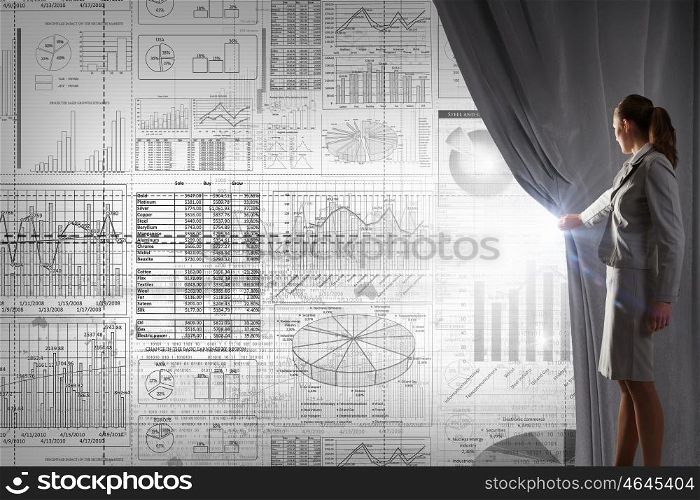 Woman presenting technologies. Young businesswoman opening curtain and presenting digital financial infographs