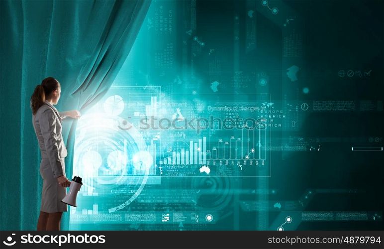 Woman presenting technologies. Young businesswoman with megaphone opening curtain and presenting digital financial infographs