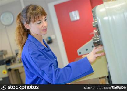 Woman pressing buttons on machine