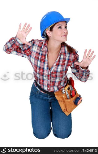 Woman pressing her hands and face against a glass barrier