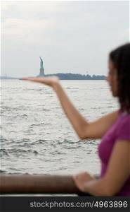 Woman pretending to hold statue of liberty
