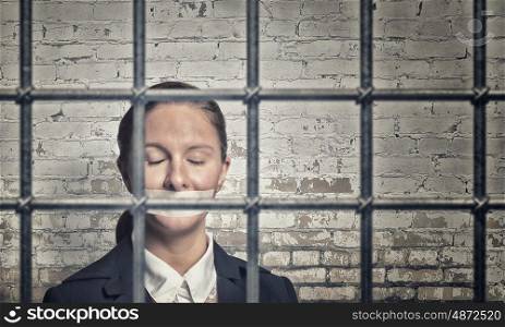 Woman prisoned in ward. Young speechless businesswoman in ward with tied hands and adhesive tape on mouth