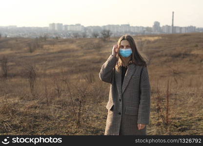 Woman protecting from coronavirus. Covid-19. Photo of a woman wearing protective mask against infectious diseases, coronavirus, covid-19 and flu outdoors. copy space. Woman protecting from coronavirus. Covid-19. Photo of a woman wearing protective mask against infectious diseases, coronavirus, covid-19 and flu outdoors. copy space.