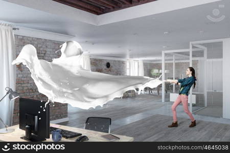 Woman pull white fabric. Young woman in office interior pulling white blank fabric