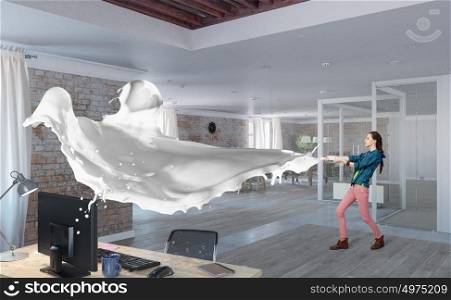 Woman pull white fabric. Young woman in office interior pulling white blank fabric