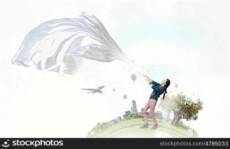 Woman pull white fabric. Young woman outdoors pulling white blank fabric