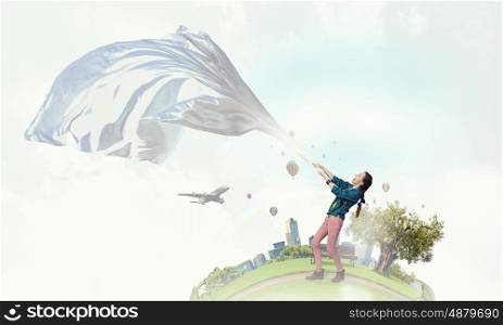 Woman pull white fabric. Young woman outdoors pulling white blank fabric