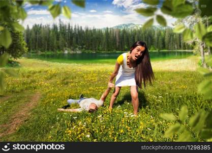 Woman pulling a slapped man after a picnic on nature. Woman pulling a slapped man