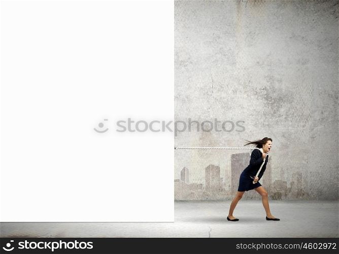 Woman pulling banner. Young determined businesswoman pulling white blank banner with rope