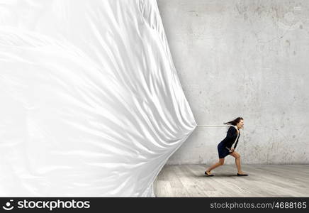 Woman pulling banner. Young determined businesswoman pulling white blank banner with rope