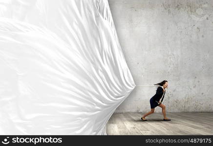 Woman pulling banner. Young determined businesswoman pulling white blank banner with rope