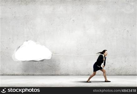 Woman pulling cloud. Young businesswoman pulling white cloud with rope