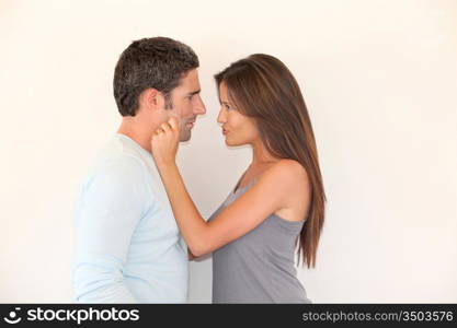 Woman pulling on boyfriend&acute;s cheeks