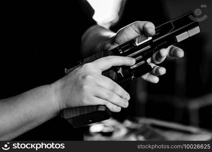Woman pulling pistol on sport shooting training