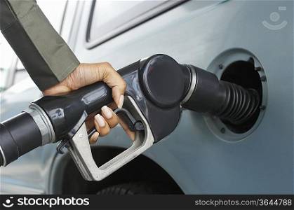Woman pumping gas, close up of hand