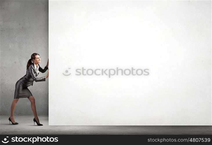 Woman pushing banner. Attractive businesswoman pushing white blank wall. Place for text